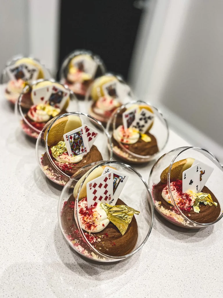 Some playful desserts at a dinner party, made with gold leaf and playing card decorations