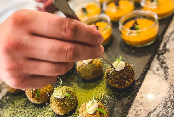 A private chef delicately assembling some canapés