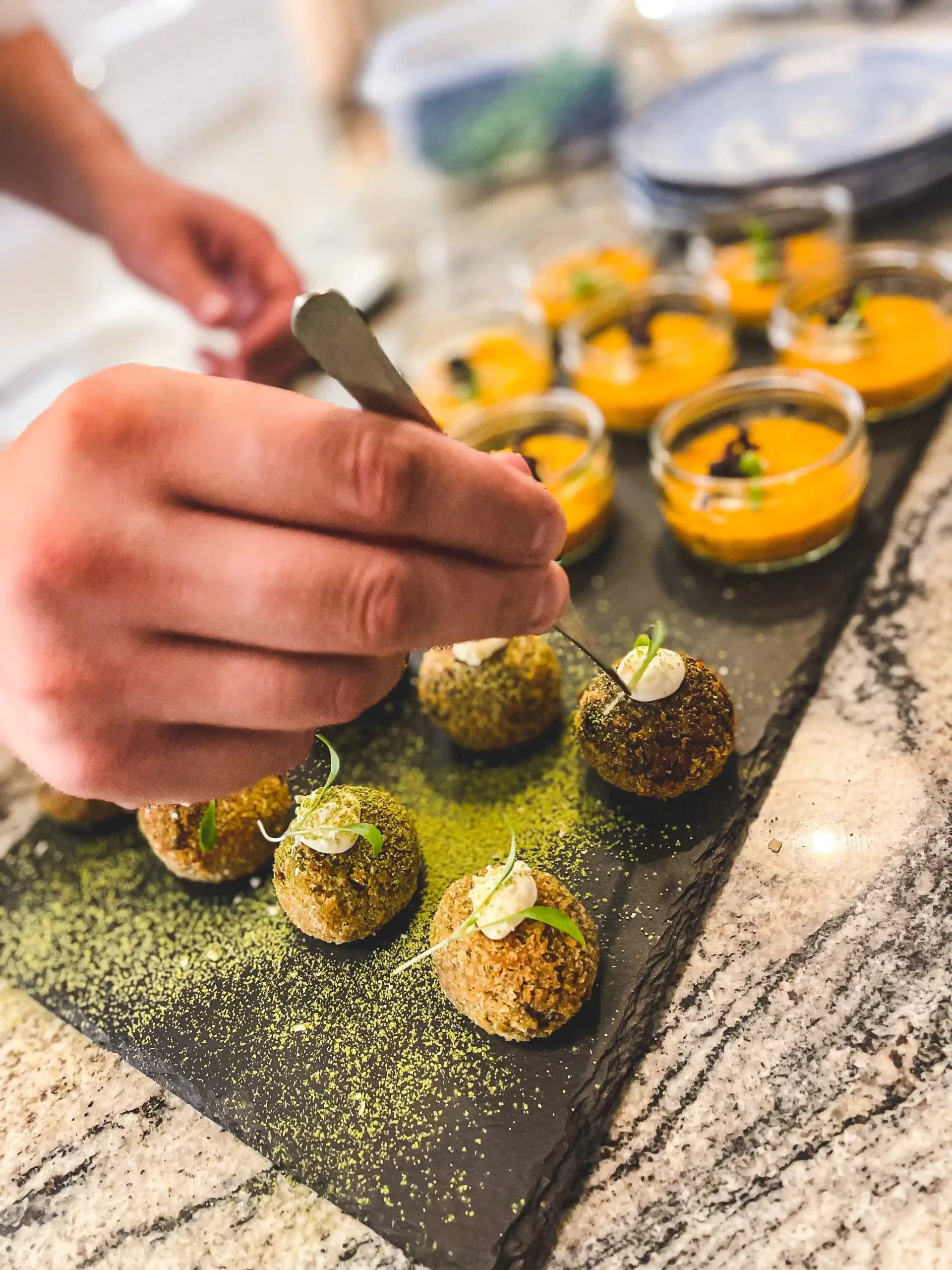 A private chef delicately assembling some canapés