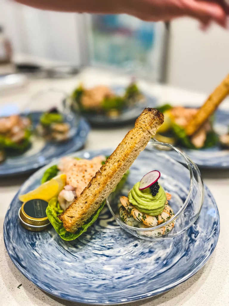 A glorious prawn starter served on a blue plate for dinner party guests