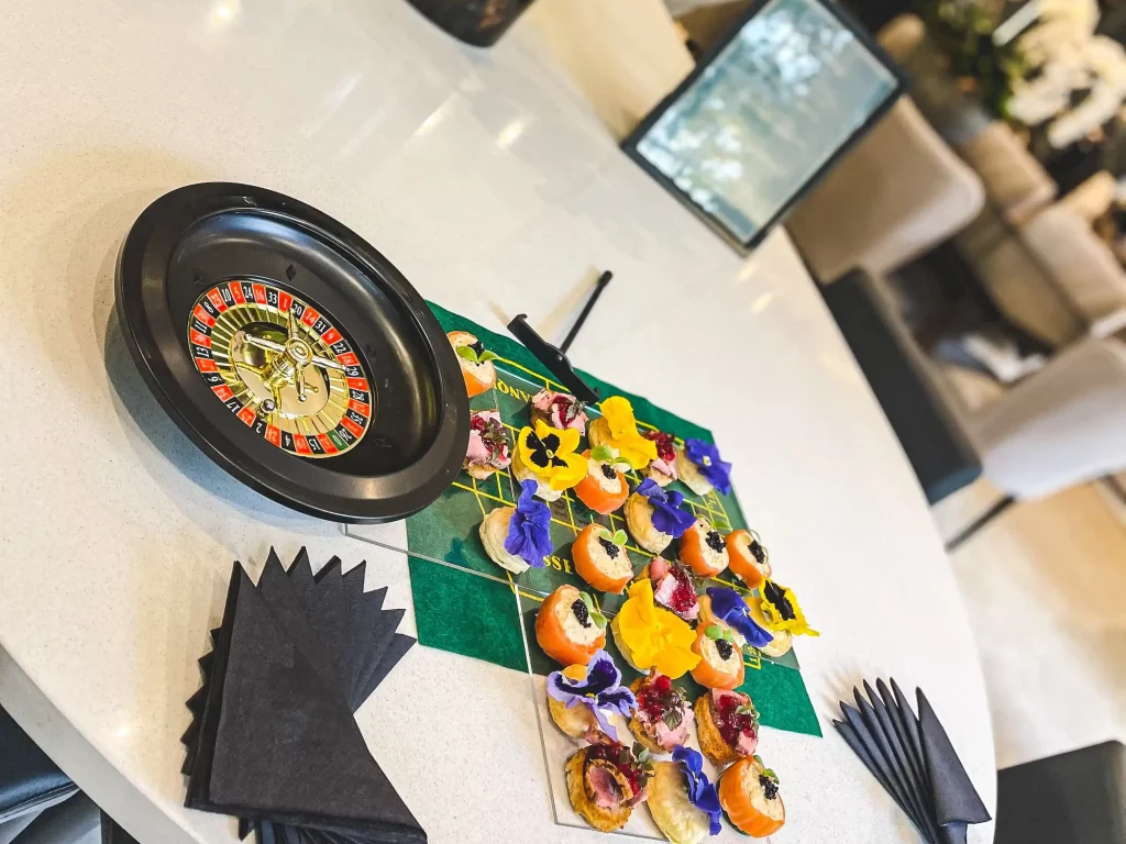 A table laid out with canapés and a casino style dinner party game