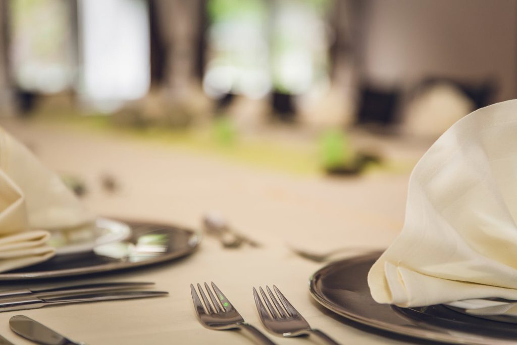 a dinner table with table cloth and napkins